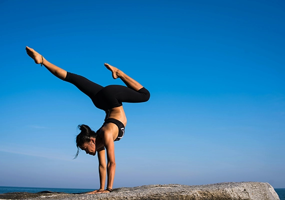 Sunset with woman doing yoga pose.
