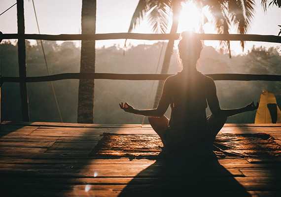 Sunset with woman doing yoga pose.